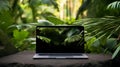 Laptop in green vegetation, representing eco friendliness in build materials