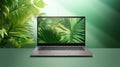 Laptop in green vegetation, representing eco friendliness in build materials