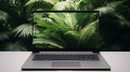 Laptop in green vegetation, representing eco friendliness in build materials