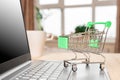 Laptop and grocery trolley. Online shopping concept. Shopping Cart on Laptop Royalty Free Stock Photo