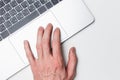 Laptop and hand, top view. The user works on a modern laptop using a trackpad. Modern technology Royalty Free Stock Photo