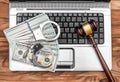 Laptop with handcuffs, gavel and money on wooden table. Top view Royalty Free Stock Photo