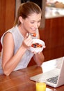 Laptop, happy and woman with fruit breakfast in home for website, internet and reading news blog. Smile, morning and Royalty Free Stock Photo