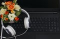 Laptop headphones bouquet of flowers black keyboard