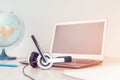 Laptop with headphones on white desk Royalty Free Stock Photo