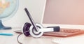 Laptop with headphones on white desk Royalty Free Stock Photo