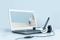 Laptop with headphones on white desk Royalty Free Stock Photo