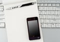 Laptop with Hi-Tech mobile phone and notepad. Royalty Free Stock Photo