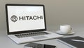 Laptop with Hitachi logo on the screen. Modern workplace conceptual editorial 3D rendering