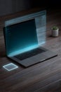 Laptop with holographic display projecting digital interface above keyboard, showcasing advanced technology and modern workspace Royalty Free Stock Photo