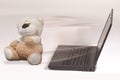 Laptop and injured toy bear Royalty Free Stock Photo