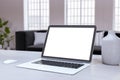 Laptop with isolated screen on desk, office mockup. Workspace concept. Royalty Free Stock Photo