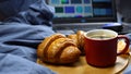 laptop keyboard and Breakfast on the bed of coffee and croissants Royalty Free Stock Photo