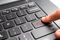 Laptop keyboard with finger pressing shopping cart key Royalty Free Stock Photo