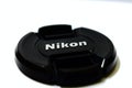 Laptop and Nikon lens cap