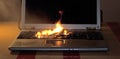 The laptop keyboard on the table caught fire Royalty Free Stock Photo