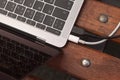 Laptop keyboard and two wires close-up on a bench Royalty Free Stock Photo