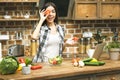 Laptop on kitchen table and cooking beautiful smiling girl. Food blogger concept. Relaxing