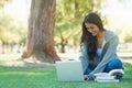 Laptop, lawn or happy woman in nature with books for learning knowledge, information or education. Smile, textbook or