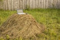 Laptop lies on a haystack on the background wooden fence outdoor Royalty Free Stock Photo