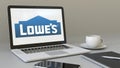 Laptop with Lowe`s logo on the screen. Modern workplace conceptual editorial 3D rendering