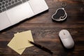 Laptop, magnifier, mouse, pen and paper for taking notes on the dark wooden table. Close up for your text