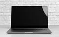 Laptop in a metal case with a black blank screen. The laptop on the table. Close up Royalty Free Stock Photo