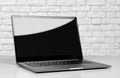 Laptop in a metal case with a black blank screen. The laptop on the table. Close up Royalty Free Stock Photo