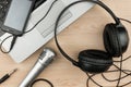 Laptop, microphone, headsets lies on a wooden table Royalty Free Stock Photo