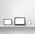 Laptop, mobile phone and digital tablet pc on white concrete wall shelf. Square background Royalty Free Stock Photo