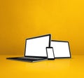 Laptop, mobile phone and digital tablet pc on yellow office desk Royalty Free Stock Photo