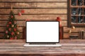 Laptop mockup in Santa Claus wooden cottage with Christmas decorations