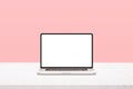 Laptop mockup on white desk with pastel pink background