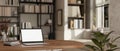 A laptop mockup is on a wooden table in a modern contemporary and cozy living room Royalty Free Stock Photo