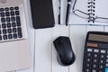 Laptop with mouse, calculator, notebook, pen and smartphone on white wooden table Royalty Free Stock Photo