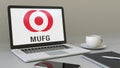 Laptop with MUFG logo on the screen. Modern workplace conceptual editorial 3D rendering