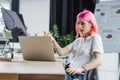 laptop near blurred businesswoman with pink