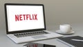 Laptop with Netflix logo on the screen. Modern workplace conceptual editorial 3D rendering