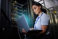 Laptop, network and data center with a black woman it support engineer working in a dark server room. Computer Royalty Free Stock Photo