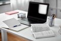 laptop, notebook and book on table at home office Royalty Free Stock Photo