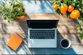 Laptop, Notebook, Coffee, and Oranges on a Wooden Table Royalty Free Stock Photo