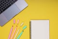 Laptop, notepad, colored pencils. back to school. Isolated yellow background Royalty Free Stock Photo