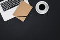 Laptop, notepad and a cup of coffee on a black background isolated, top view. Royalty Free Stock Photo
