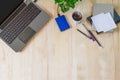 Laptop with office supplies, green plant and hot black coffee with smoke on vintage grunge wooden desk background Royalty Free Stock Photo