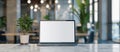A laptop is open on a table in front of a potted plant by AI generated image Royalty Free Stock Photo