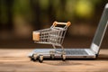 the laptop is open, there is an empty shopping cart on keyboard Royalty Free Stock Photo