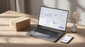 laptop open to e-commerce dashboard with charts and data, smartphone displaying related app, shipping box on desk. Represents Royalty Free Stock Photo