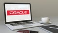 Laptop with Oracle Corporation logo on the screen. Modern workplace conceptual editorial 3D rendering