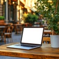 Laptop on Outdoor Cafe Table Perfect Remote Work Setting Royalty Free Stock Photo