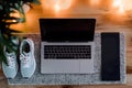 A laptop and a pair of running shoes, concept for work life balance Royalty Free Stock Photo